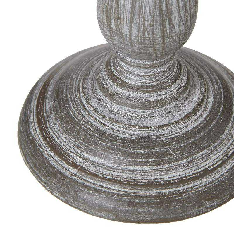 Close-up of Augusta lamp's vintage column base with carved detailing and antique finish."
