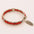 Elegant red beaded bracelet with a handcrafted 925 silver feather charm